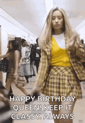 A Woman Is Walking Down A Hallway Wearing A Plaid Skirt And A Yellow Top . GIF