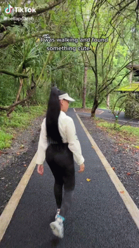 A Woman Is Walking Down A Path In The Woods With A Caption That Says I Was Walking And Found Something Cute GIF