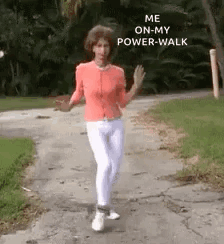 A Woman Is Walking Down A Sidewalk With The Words `` Me On My Power Walk '' Written On The Side Of Her Face . GIF