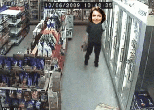 A Woman Is Walking Down A Store Aisle With The Date 10/06/2009 GIF