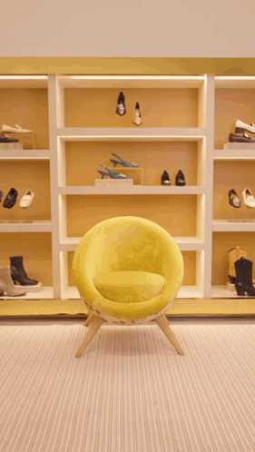 A Woman Is Walking In A Store Holding A Green Purse GIF