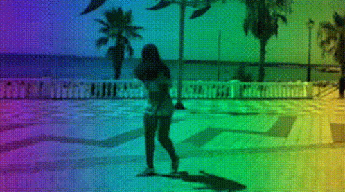 A Woman Is Walking On A Sidewalk With A Rainbow Background GIF
