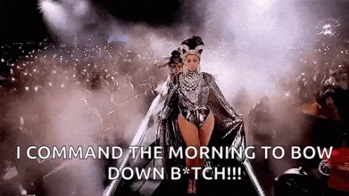 a woman is walking on a stage in front of a crowd and says `` command the morning to bow down b * tch '' .