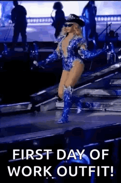 a woman is walking on a stage wearing a police uniform and boots .