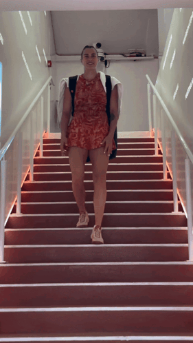 a woman is walking up a set of stairs
