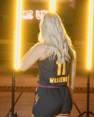 a woman is wearing a black jersey with the number 11 on it
