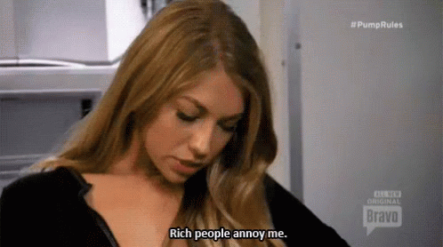 A Woman Is Wearing A Black Shirt And Saying `` Rich People Annoy Me . '' GIF