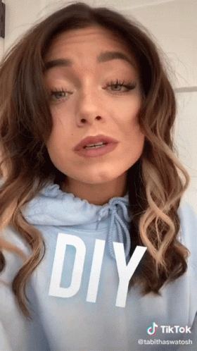 A Woman Is Wearing A Blue Hoodie With The Word Diy On It GIF