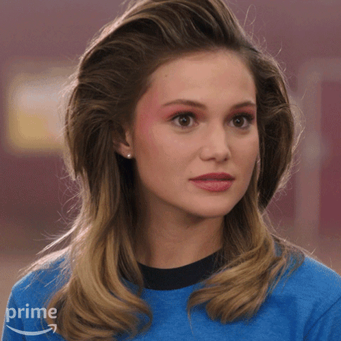 A Woman Is Wearing A Blue Shirt With An Amazon Prime Logo On It GIF