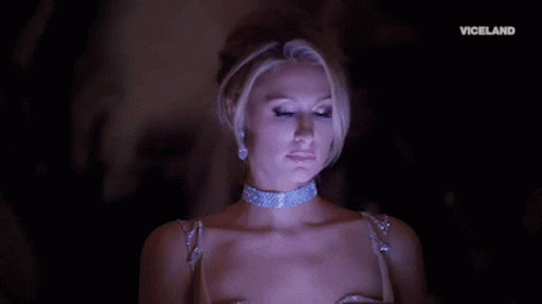 A Woman Is Wearing A Choker And Earrings And The Word Viceland Is On The Bottom GIF