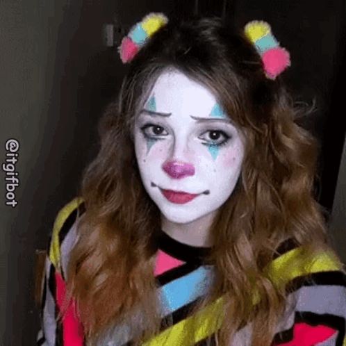 A Woman Is Wearing A Clown Costume And Making A Sad Face . GIF