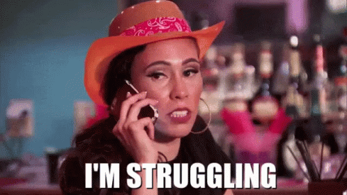 A Woman Is Wearing A Cowboy Hat And Talking On A Cell Phone . GIF