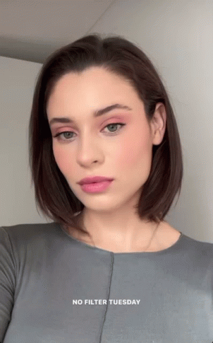A Woman Is Wearing A Grey Shirt With The Words " No Filter Tuesday " On The Bottom GIF