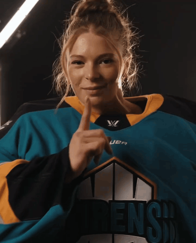 A Woman Is Wearing A Jersey That Says Dens GIF