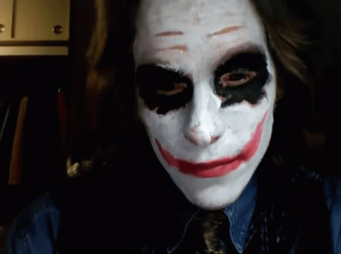 A Woman Is Wearing A Joker Mask And Smiling At The Camera GIF