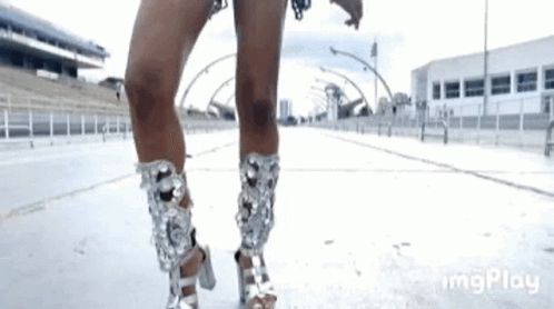 a woman is wearing a pair of silver high heels .