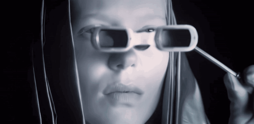 A Woman Is Wearing A Pair Of Sunglasses That Have A Hole In Them GIF