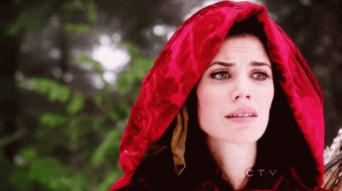 A Woman Is Wearing A Red Hood And Holding A Sword . GIF