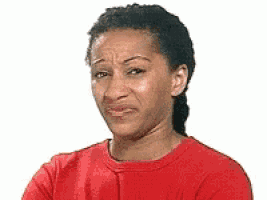 A Woman Is Wearing A Red Shirt And Making A Funny Face . GIF