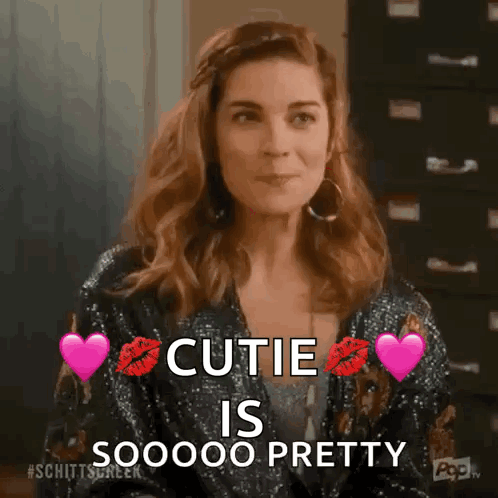 Woman In Sequined Jacket With Hearts And Cutie Text GIF
