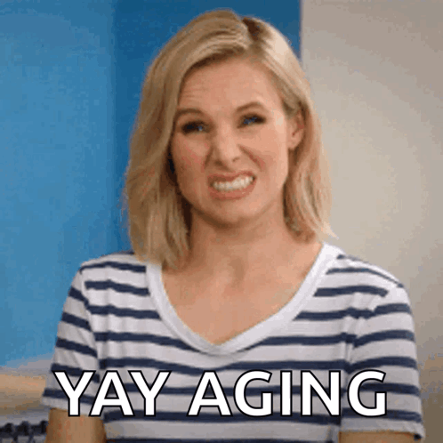 A Woman Is Wearing A Striped Shirt And Says Yay Aging GIF