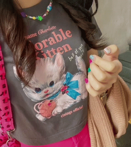 A Woman Is Wearing A T-Shirt That Says " Adorable Kitten " GIF