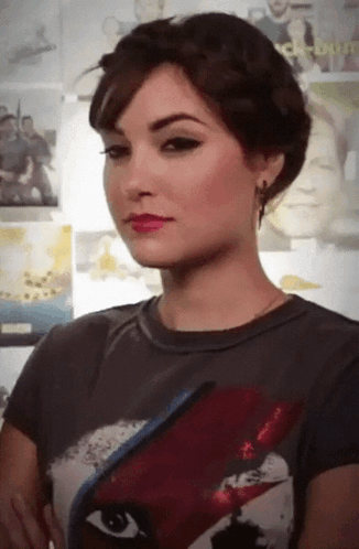 A Woman Is Wearing A T-Shirt With A Picture Of David Bowie On The Front GIF