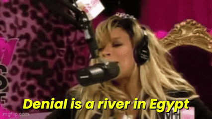 A Woman Is Wearing Headphones And Talking Into A Microphone . GIF