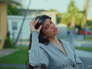 A Woman Is Wearing Sunglasses And Making A Funny Face In A Video For Vevo GIF