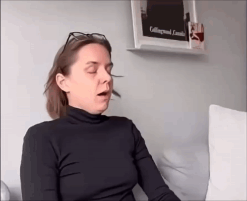 Woman Yawning On Couch In Front Of Callingwood Sign GIF