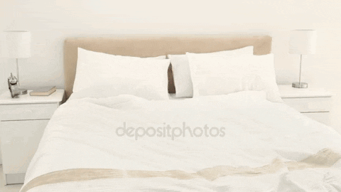 A Woman Jumping On A Bed With The Word Depositphotos On The Bottom Left GIF