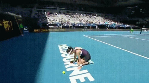 A Woman Kneeling Down On A Tennis Court With The Word Melbourne On The Ground GIF