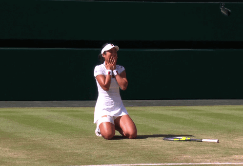 A Woman Kneeling On A Tennis Court With A Racket On The Ground GIF