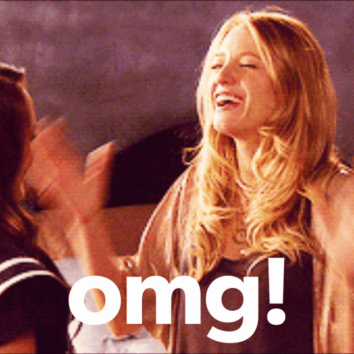 A Woman Laughs While Another Woman Applauds In Front Of A Sign That Says " Omg " GIF