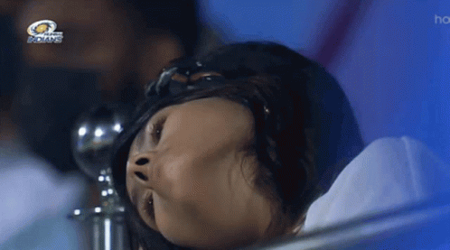 A Woman Laying In A Hospital Bed With The Indians Logo Above Her GIF