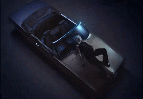 A Woman Laying In The Back Of A Car GIF