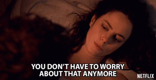 A Woman Laying On A Bed With The Words " You Don T Have To Worry About That Anymore " GIF
