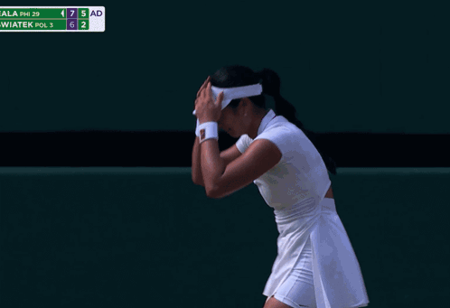 A Woman Laying On A Tennis Court With A Towel Around Her Head GIF