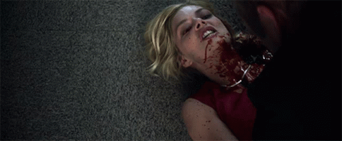 A Woman Laying On The Floor With Blood On Her Neck GIF