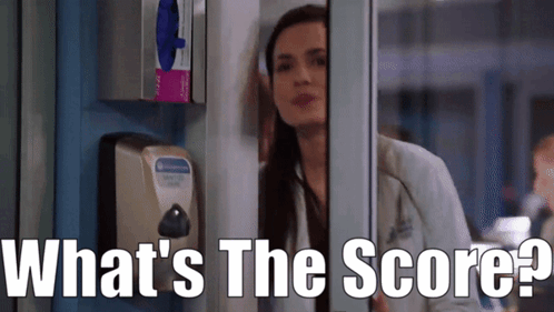 A Woman Leaning Against A Wall With The Words What 'S The Score Written On The Bottom GIF