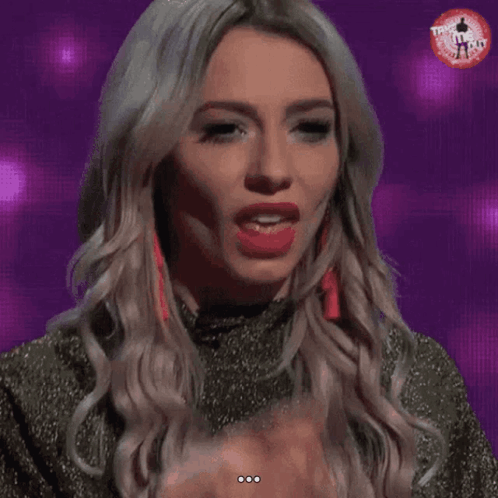 A Woman Licks Her Finger While Wearing A T-Shirt That Says ' T-Shirt ' On It GIF
