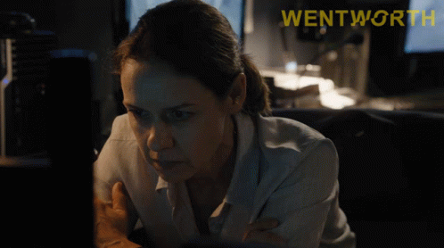 a woman looking at a computer screen with the word wentworth on the bottom right