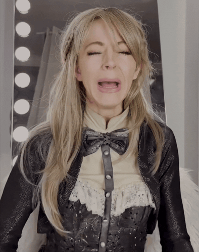 A Woman Making A Funny Face With Her Eyes Closed And Her Mouth Open GIF