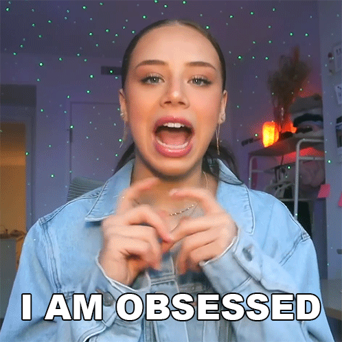A Woman Making A Heart With Her Hands And The Words I Am Obsessed Above Her GIF