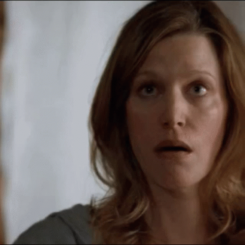 A Woman Making A Surprised Face With Her Mouth Open GIF