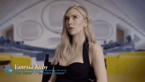 A Woman Named Vanessa Kirby Is Sitting In A Chair In Front Of An Airplane GIF