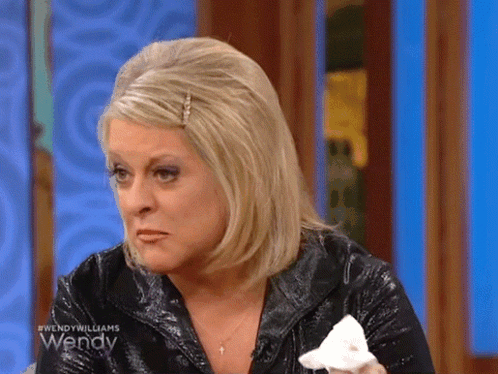 A Woman On Wendy Williams Is Crying And Holding A Tissue GIF