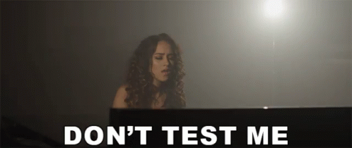 A Woman Playing A Piano With The Words " Do N't Test Me " Behind Her GIF
