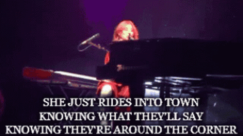 A Woman Playing A Piano With The Words She Just Rides Into Town Above Her GIF