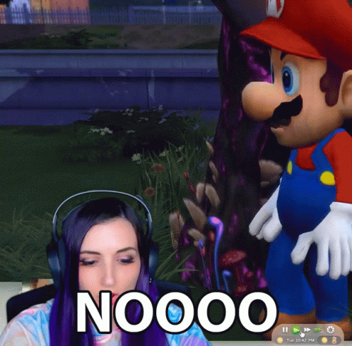 A Woman Playing A Video Game With A Mario Mascot Behind Her That Says Noooo GIF